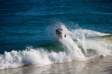 White frothy surfing waves rolling in at Ocean Beach, Bunbury, Western Australia on a fine sunny winter afternoon are inviting to intrepid surfers seeking exciting exercise.