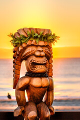 Hawaiian Tiki Statue with an amazing sunrise in the background. The tiki is dressed up with...
