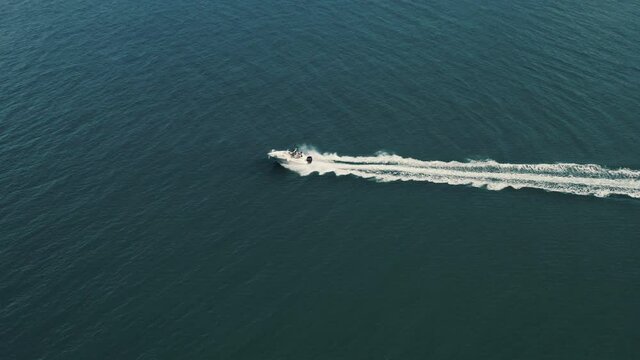 Aerial view on a boat riding in the sea.