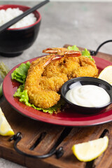 Ebi Furai or Tempura Shrimp or Prawn, Japanese Traditional Cuisine made from Deep Fried Shrimp Coated with Bread Crumb, served with mayounaise sauce, lemon slices, and a bowl of rice with chopstick.  