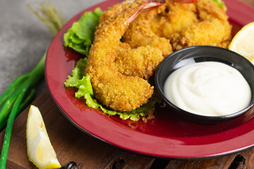 Ebi Furai or Tempura Shrimp or Prawn, Japanese Traditional Cuisine made from Deep Fried Shrimp Coated with Bread Crumb, served with mayounaise sauce, lemon slices, and a bowl of rice with chopstick.  