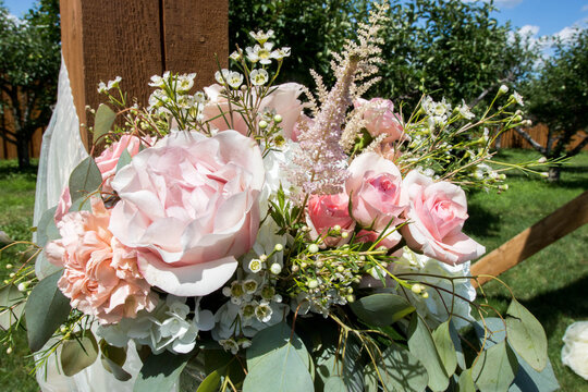 Pink flower bouquet of fresh peonies and roses at a wedding