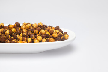 Crunchy Roasted Chana Masala in a white Ceramic oval bowl, made with Bengal Grams or Chickpeas....
