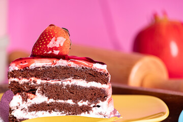 Delicious homemade chocolate cake with strawberry and sauce on top