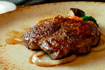 High quality Wagyu beef steak with sauces arranged on a plate with vegetables, Japanese food 