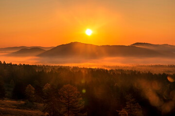 Magnificent sunrise over Mount Eseikey in the Ural Mountains, the beginning of an autumn day.