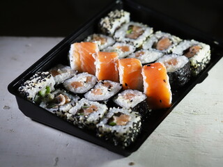 set sushi in black plastic box