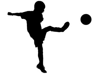 シュートするサッカー少年のシルエット