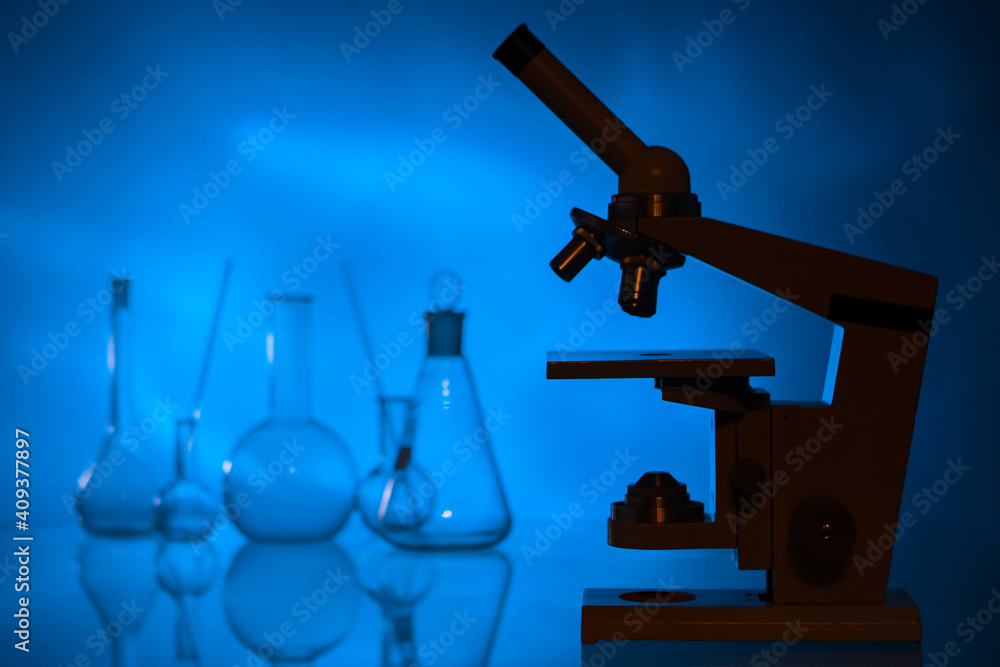 Poster microscope as a symbol of laboratory research. iledovinia in chemical laboratory. medical flasks in 