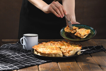 apple pie with milk on a wooden background. Rustic style.