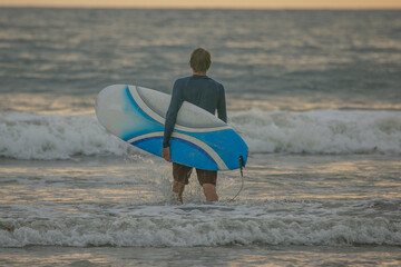 Surfer in Tamarindo Beach of Costa Rica trying to learn surf