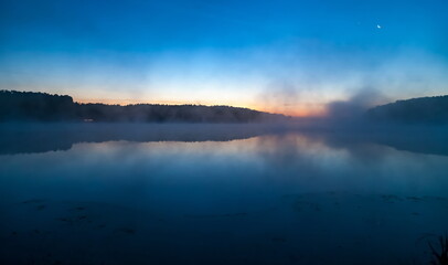 Mist over the lake dawn early morning in the summer