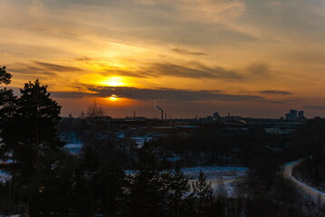 Sunset over the industrial area of the city in winter
