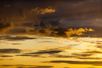 Clouds illuminated by the sunset yellow-orange sun