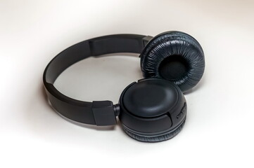 Black wireless headphones for audio electronic devices close up on white background