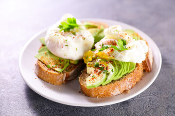 bread sliced with avocado and poached egg