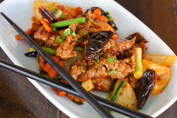 Szechuan beef on white plate