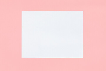 Top view of empty copy space for text white paper in the middle on pink background with valentines. Valentines day concept festive