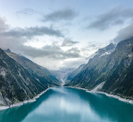 Aerial drone shot of Schlegeisspeicher resevoir with galcier view at dusk