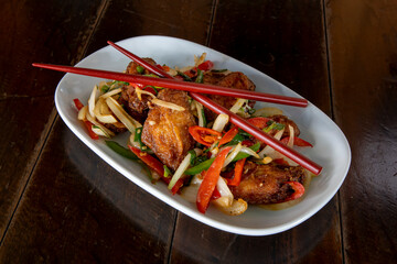 Chili chicken wings on a white plate