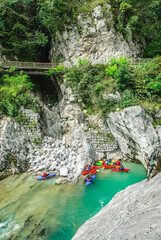 Mehrere Kajakfahrer machen Pause in einer Felsnische in der Kobarid-Schlucht auf der Soca