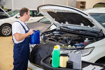 Changing the oil in the car in the technical center.
