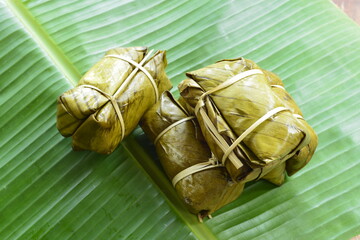 Thai traditional dessert Sticky rice wrapped in banana leaf steamed or boiled.