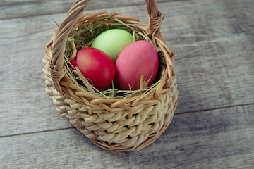 Fototapeta na wymiar eggs in dry grass straw wicker basket