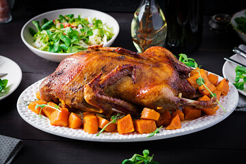 Homemade baked duck. Crispy whole roast duck. Thanksgiving or Christmas dinner. Roast duck with...