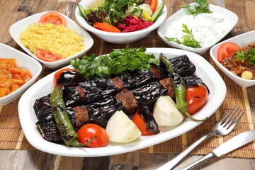 Aubergine kebab served with onion and grilled tomatoes