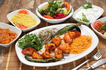 grilled chicken shish kebab served with grilled tomato and pepper