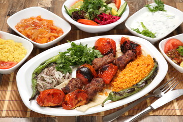 Turkish kebab with tomatoes served with grilled tomato pepper and onion