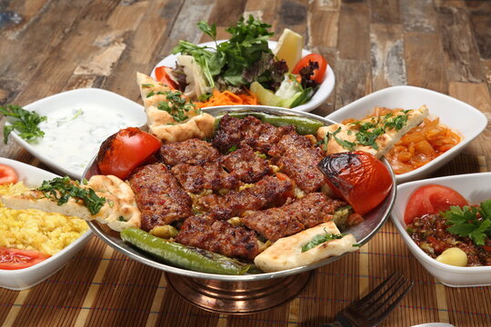 Adana kebab on the eggplant puree with butter