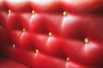 Red leather texture of the sofa finish with buttons. Red leather abstract background.