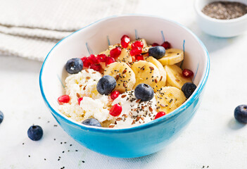 Cottage cheese with bananas, blueberries. Dietary breakfast for summertime.