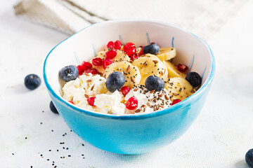 Cottage cheese with bananas, blueberries. Dietary breakfast for summertime.