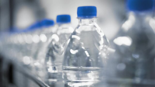 Plastic water bottles on a factory conveyor.
