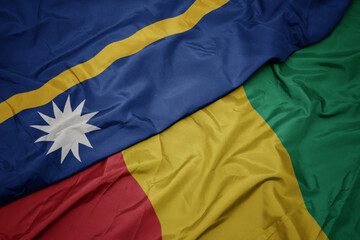 waving colorful flag of guinea and national flag of Nauru .