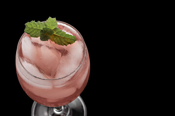Rose Wine Cocktail with Gin, isolated against a black background.