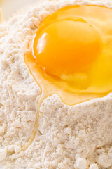 broken egg in flour close-up