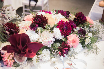 pink, white, yellow peonie flowers decoration a table by a florist at a wedding © Abby