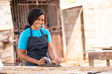 female african carpenter smiling while working