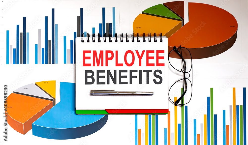 Aufkleber notebook with tools and notes with text employee benefits on the charts