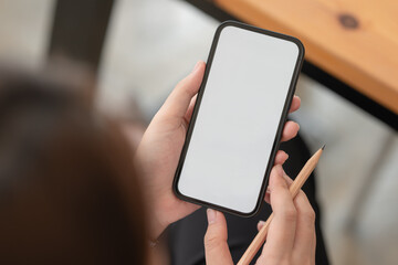 Close-up view of businesswoman searching for important information on smartphone for her current project.