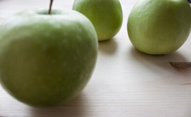 Set of three green granny smith apples with water droplets isolated on white background.