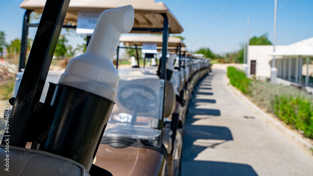 Wall mural background image of multiple golf carts parked in order.
