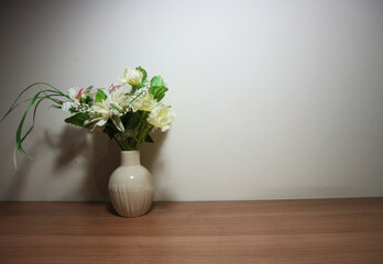 White flowers in vintage vase on wooden table, floor, gray cement wall Stylish stock image format for banner templates, text artwork, quotes, fonts, festivals