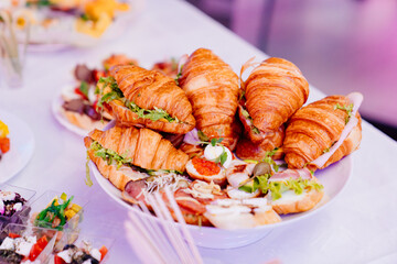 snacks in a white plate on the table for the banquet. 