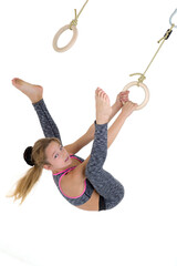 Girl flipping upside down on gymnastic rings