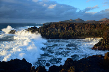 High waves at Los Hervideros in the evening sun. West coast of Lanzarote, Spain.